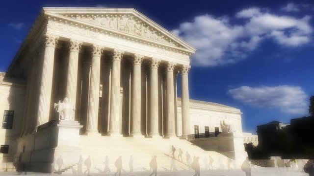Figures and clouds moving in hazy timelapse as the Supreme Court of the United States building stands in the Washington DC sun