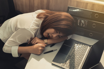 Asian woman working in office,young business woman stressed from work overload with a lot file on the desk,Thailand people