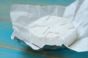 cheese camembert on the blue wooden background