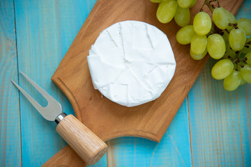 cheese camembert with a fork for cheese - obrazy, fototapety, plakaty