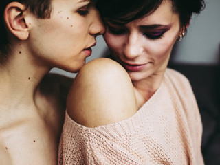 Close-up of young romantic couple is kissing and enjoying the company of each other at home