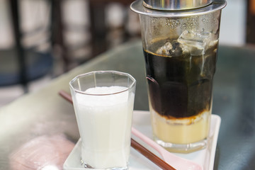 Close-up Vietnamese Drip Coffee and Ice mug served with milk, Iced black coffee.
