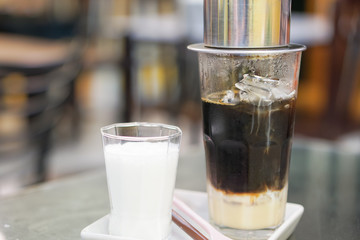 Close-up Vietnamese Drip Coffee and Ice mug served with milk, Iced black coffee.