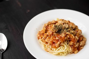 Spaghetti on black wooden background