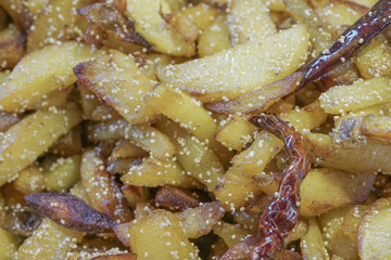 Fried potato pieces with fried red chilly
