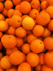 Healthy fruits, orange fruits background many orange fruits - orange fruit background in a supermarket super store