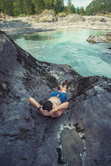 Man resting at river in Altai Mountains territory