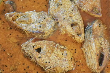 Hilsa fish pieces on a plate.