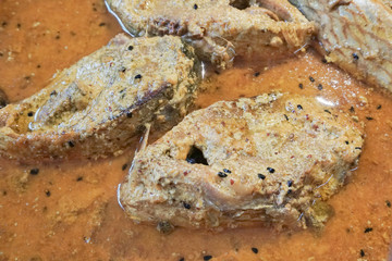 Hilsa fish pieces on a plate.