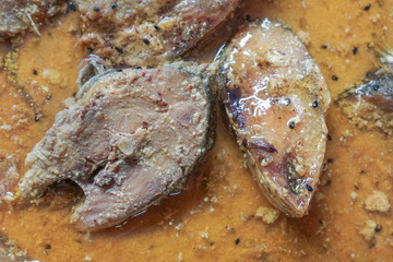 Hilsa fish pieces on a plate.