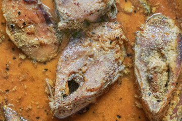 Hilsa fish pieces on a plate.
