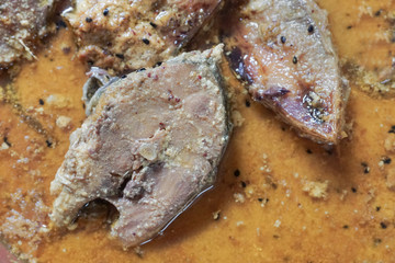 Hilsa fish pieces on a plate.