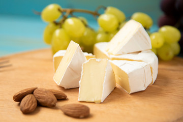 slices of cheese camembert with raspberries and nuts