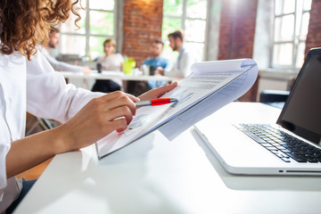 Close-up image of a financial worker analyzing statistical data