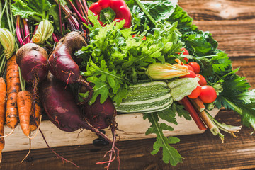 Organic produce and harvested vegetables. Fresh farm vegetable in the box on farmer market.