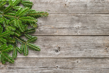 Christmas fir tree branches on wooden background, copy space