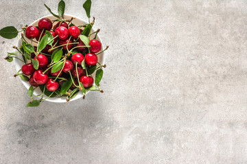 Fresh cherry on plate on white background, ripe cherries, sweet fruit, top view