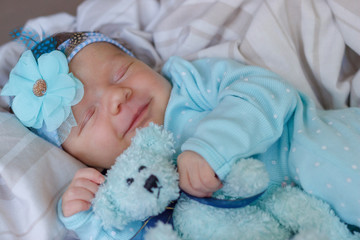Fototapeta na wymiar Sleeping newborn baby with a teddy bear