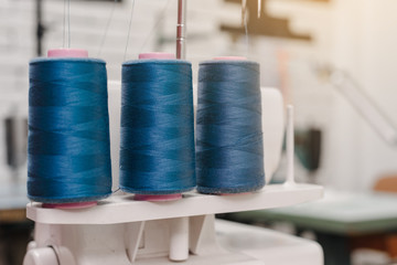 Closeup photo of threads coils on table in designer studio