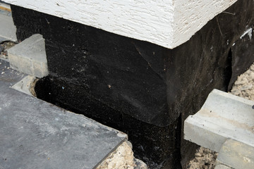 Waterproofing house foundation with spray on tar