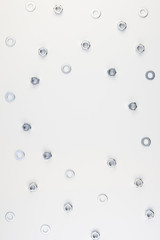 Flat lay of metal nuts on white background