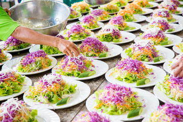 Close up mixed colorful Shredded vegetables, Purple cabbage, carrots, onions, lettuce. Food preparing in wedding catering chinese banquet. Asian food culture. image for background and copy space.