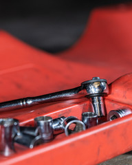 Auto repair shop tools on a creeper in a garage
