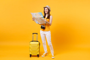 Traveler tourist woman in summer casual clothes, hat with suitcase, city map isolated on yellow...