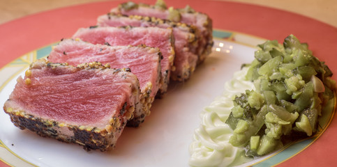 Fried tuna steak with cucumber salad