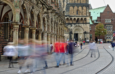 Bremen, Germany - Blurred human figures crossing the street and tram tracks in front of the...