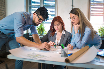  Group of young business people in smart casual wear working together in creative office