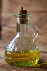 A bottle of olive oil is on the table.
