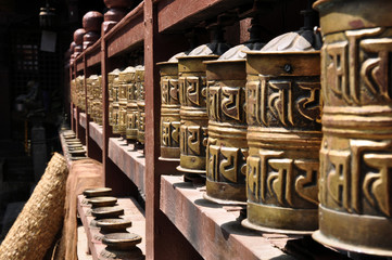 Buddhist prayer wheels in motion at the temple of Swayambhunath or monkey temple, Kathmandu, Nepal