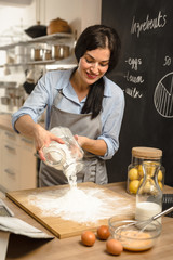 Woman pouring flour on table. Preparing dough for pie