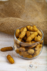 Peanuts in an open glass jar