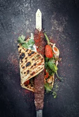 Plexiglas foto achterwand Traditional Adana kebap on a skewer with tomato and yogurt on a flatbread © HLPhoto