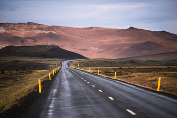 Fototapeta na wymiar Road (highway) N1 in Iceland. Geothermal valley of Hverir near Namafjall and pass Namaskard