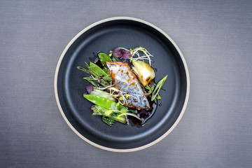 Modern style Japanese bonito tuna fish filet with vegetable glazed in teriyaki sauce as top view on...