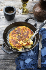 Traditional Swiss hash browns as side dish as closeup in a frying pan
