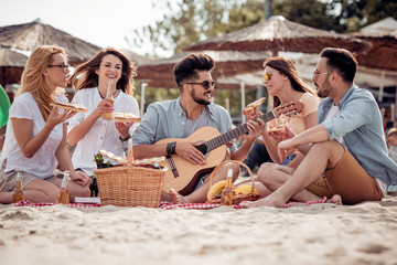 Group of friends having a party on the beach