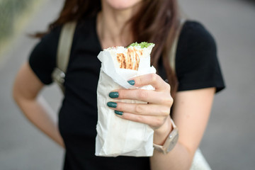 Close-up of bitten Shawarma in a woman's hand
