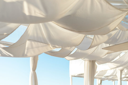 awnings in the form of sails on the terrace, white fabric