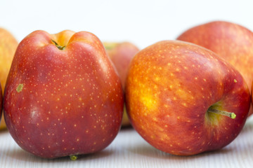 red apple on white table