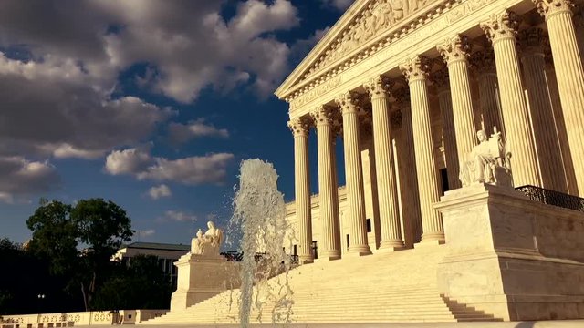 Supreme Court of the United States with a fountain in sunset light slow motion in Washington DC USA