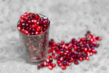 pomegranate berries on a glass beaker