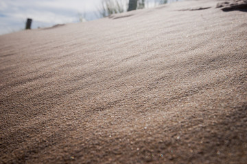 Close up of beach sand along the coast with sand pattern or beach in the summer