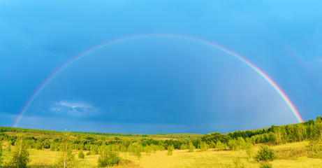Beautiful nature landscape with double full rainbow above field panorama