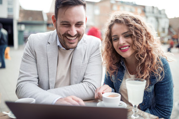 Young couple with laptop in cafe