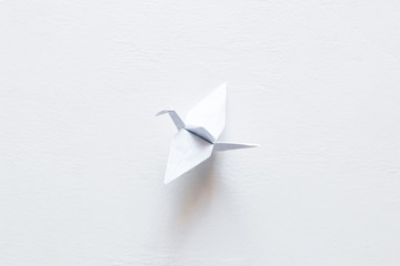 paper origami crane on white background. World Crane Day