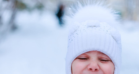 Obraz premium girls play snowballs in yard of kindergarten.